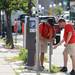 Art Fair volunteers Rick Tommelleo and Connor Friedrichsen attach a no parking sign to a meter located on E. Liberty St. in downtown Ann Arbor on Tuesday morning, July 16, 2013. Melanie Maxwell | AnnArbor.com